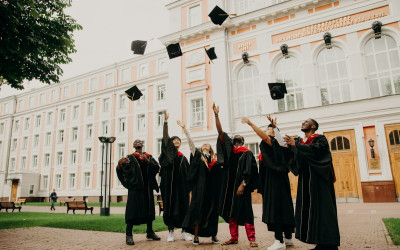 Scholarship stock image of graduates holding their caps in the air MSNZ